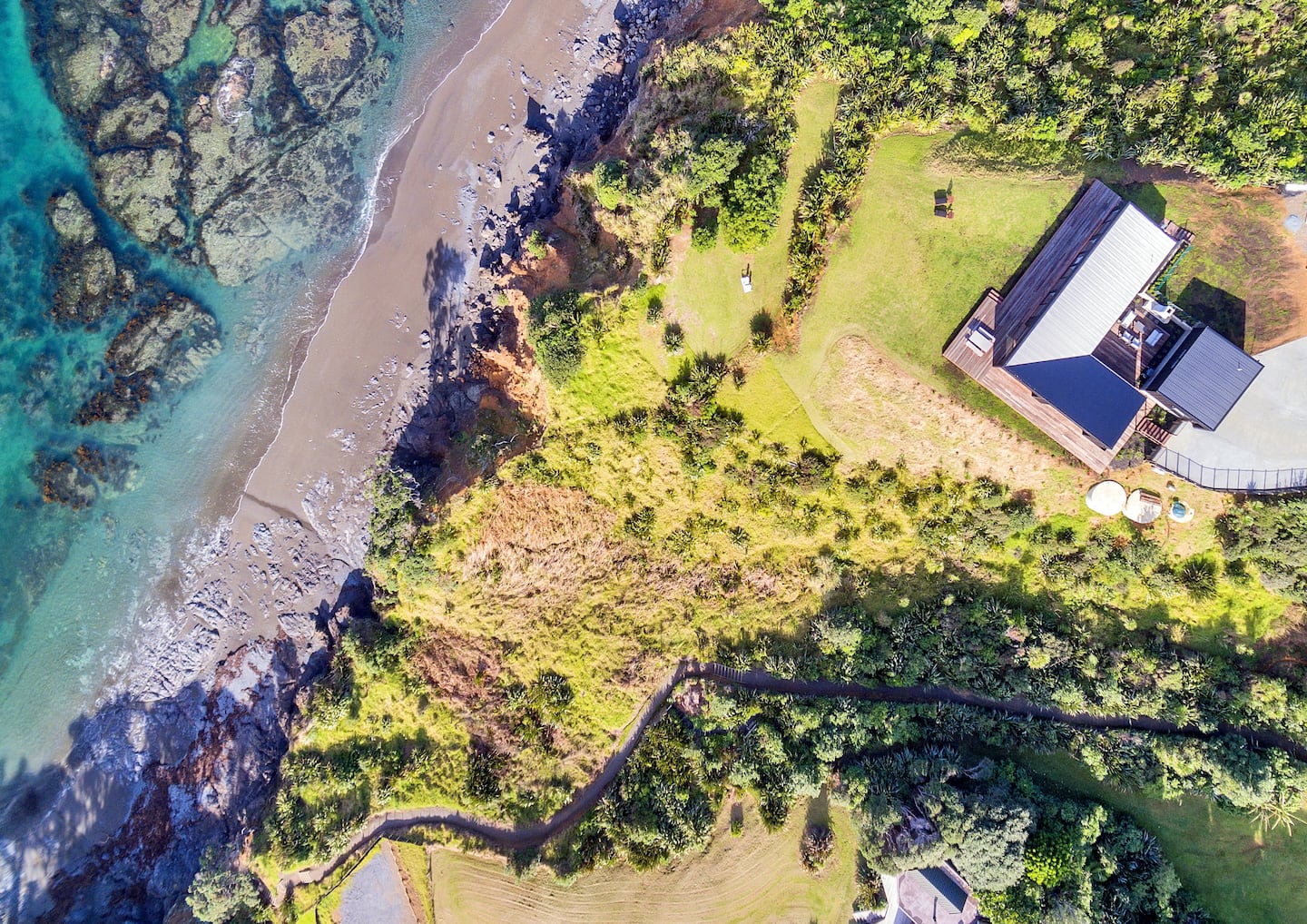 Aerial view of the beach, the house and the walkway
